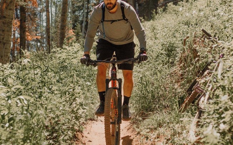 man riding a bike on a trail in the woods