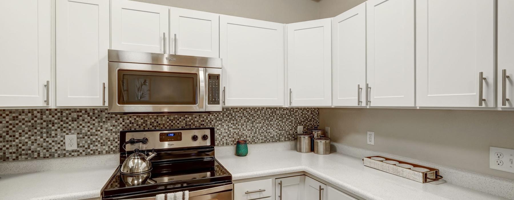 a kitchen with white cabinets